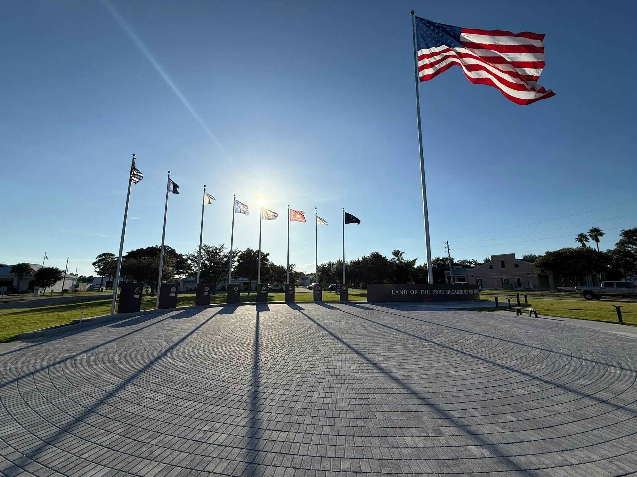 Completed veterans memorial plaza built by Badger Building Inc. — flagpoles and paved plaza