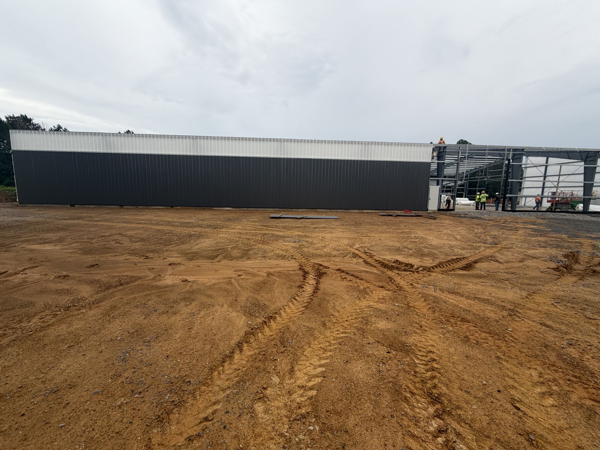 Metal wall panels installed on the Bryant Machine shop while steel framing continues on the adjoining bay