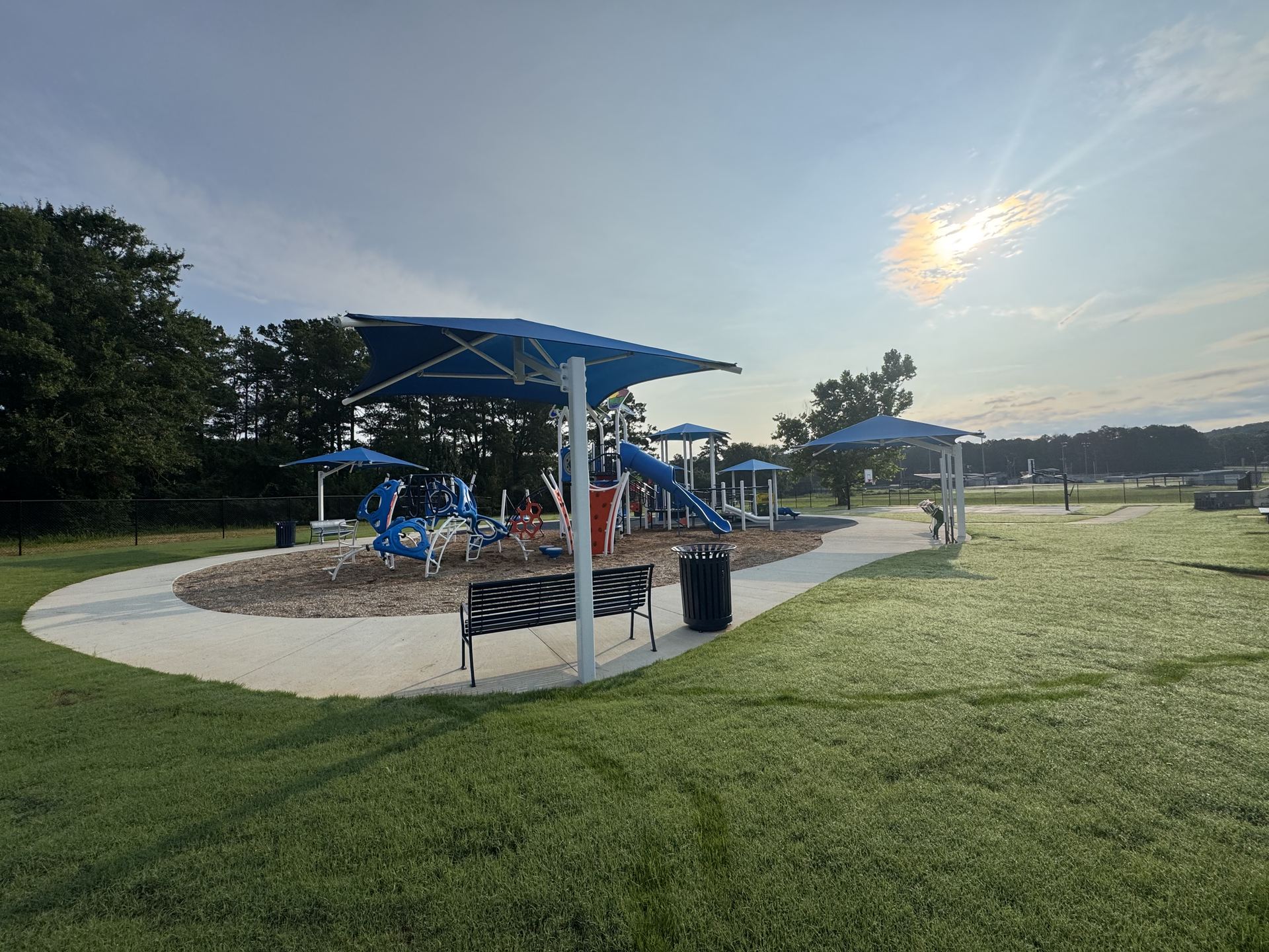 Childersburg Playground at golden hour with bench in foreground