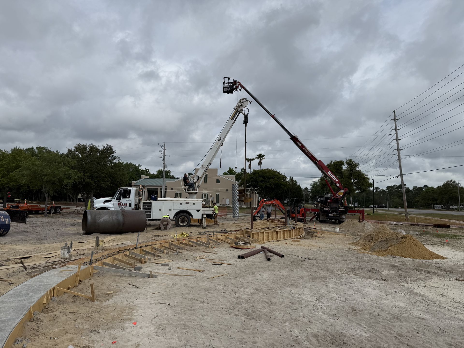 Crane crews setting the flagpole foundation at the Orange Beach veterans memorial construction site